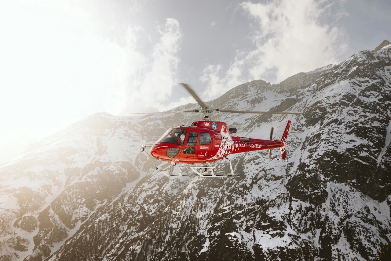 Helicopter flying with mountains in the background