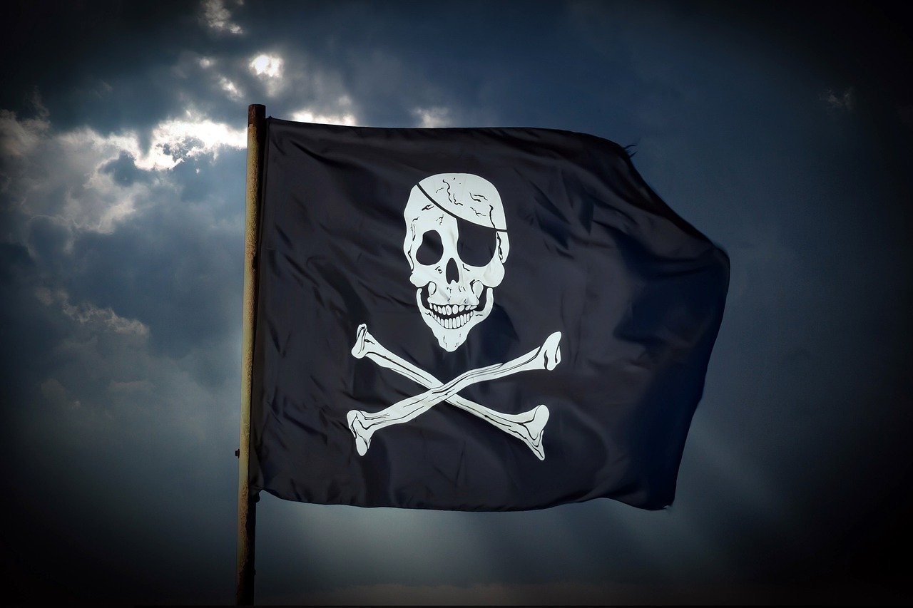 Black pirate flag with sky on the background